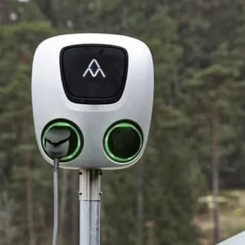 Silver Charge Amps Aura wallbox with two charging sockets on a post